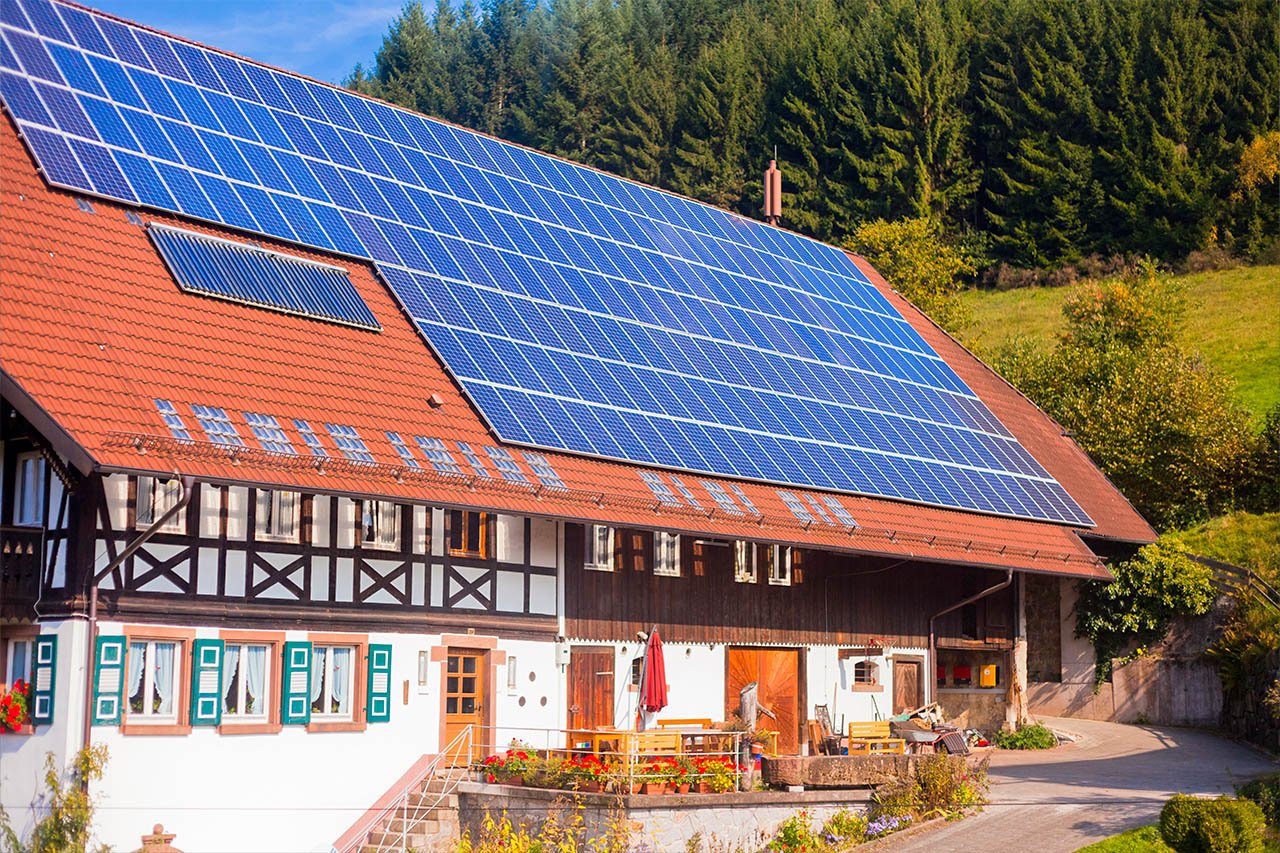 Mountain hotel with big solar panel system on the roof for green energy production and smart investment
